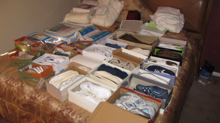 King bed full of new / gently worn shoes.