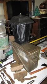 Oldest bench wood holding vise I've ever seen. Ammo box and bug zapper.