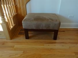 Suede-like upholstered ottoman. 2' 3" long x 1'9" wide x 1'4" tall. Good condition