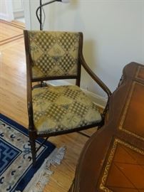 Upholstered chair with "Oasis" theme of palm trees and camels. Size: 2'11" tall at the back x 1'10" wide x 2' deep. Very good condition. Golds, browns, greens.