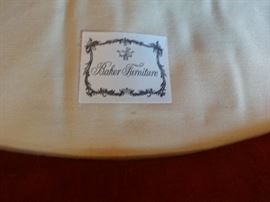 Label under the seat of the red upholstered chair.