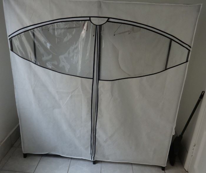 Super-sized off-season wardrobe clothes rack, zippered case. Good condition. Size: 5'1" wide x 1'8" deep x 5'5" tall.