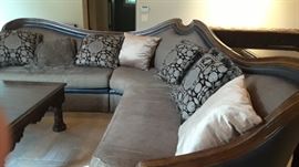 One of two large sectional sofas. Square dark coffee table by Marg Carson.