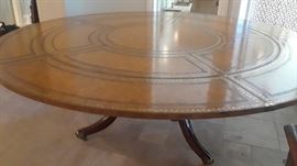 Large dining table, leather top. By Maitland Smith. Outer section is detachable.