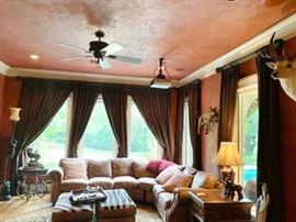 Drapes, rods, sofa, monkey floor lamp and side table are for sale. Two zebra print hassocks and bronze pieces are not available. Coyote mount is not in the sale. Deer and other mounts are on the walls in the exercise room. Please ask for directions to this detached space.