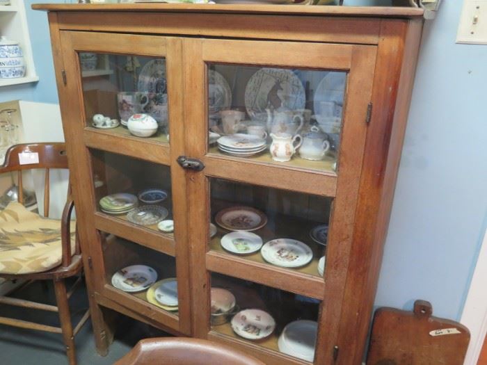 antique walnut cupboard full of childs dishes