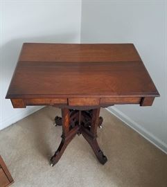 Victorian parlor table, solid wood and veneers, all hand crafted, with 4-legged pedestal base and original wheels.  28" wide, 20" deep, 30" tall.