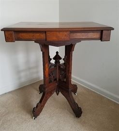 Victorian parlor table, solid wood and veneers, all hand crafted, with 4-legged pedestal base and original wheels.  28" wide, 20" deep, 30" tall.