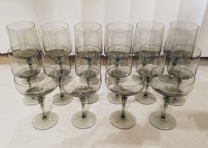 Mid Century smoky gray crystal stemware.  Water goblets, wine glasses, champagne (or sherbet). 