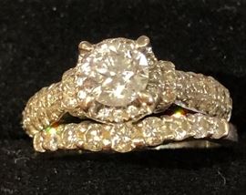 1 carat Diamond Round Brilliant Cut Solitaire surrounded by 1 carat total weight diamonds mounted in 14K White Gold .