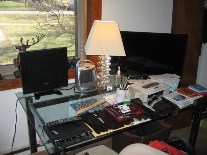 Glass Office Table, TV/DVD Player, Computer Monitor, Heater, Lamp, Cards, Woman's Gloves.