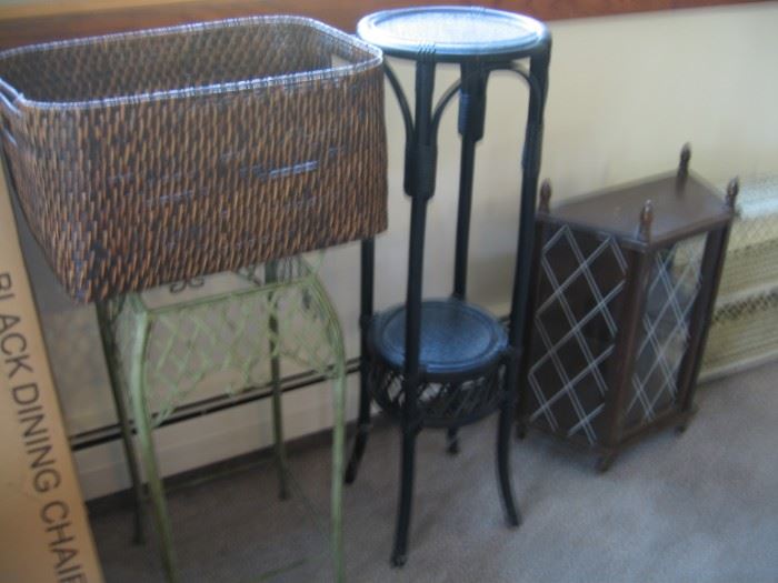 Wicker basket, glass table with metal base, glass table with wicker base, wooden display cabinet.  