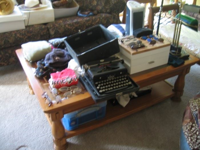 Royal Typewriter, woman's sunglasses, men's glasses, table lamps, and men's clothe.