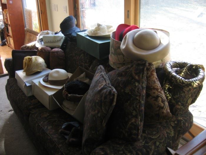 Woman's church hat's and a nice couch.