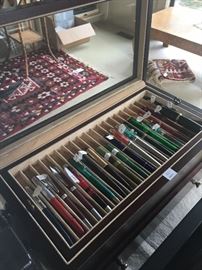 Several pens shown in display case. Case is also for sale
