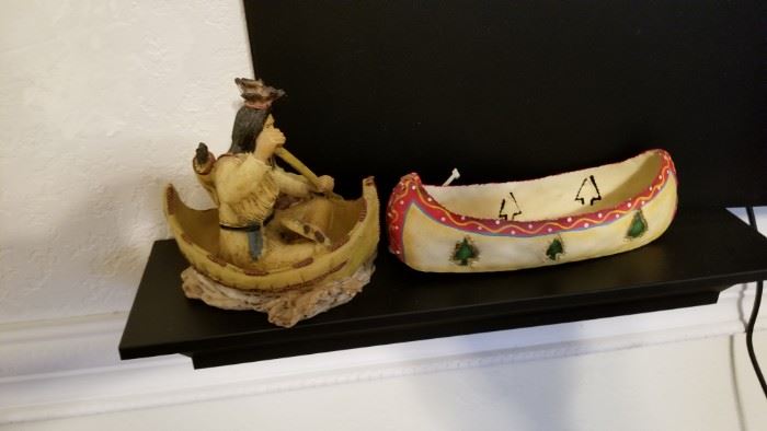 Native American figurine and canoe artwork