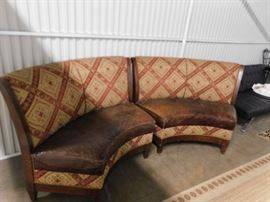 Walter E Smithe curved distressed leather seats with ornate fabric backs & accents seating booths with brass studs & wood frame