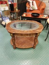 Oval wood grain style table with fancy glass insert