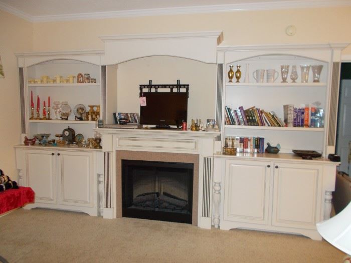 built in cabinetry with electric fireplace that must be dismantled, vases, candles, dvd players, dvds, books, vases