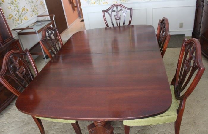 Mahogany dining table with six chairs.  