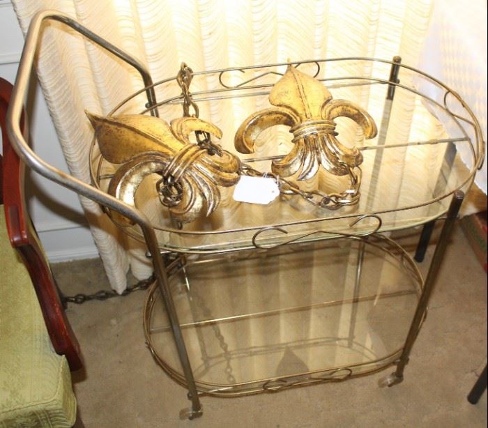 Serving cart shown with wall light fixture.