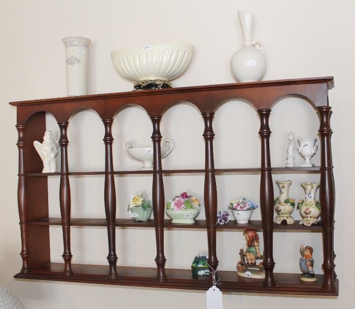 Shelf shown with various home decor pieces.