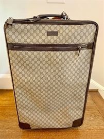 Gucci Webby monogram roller luggage.