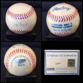 Signed and certified baseball by YOGI BERRA.  It also comes with an acrylic case.  Estate sale price: $350
