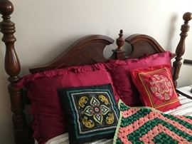 Double bed and assorted pillows and blankets.