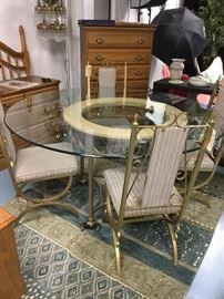 62-inch round beveled glass table on brushed aluminum frame. Six chairs.