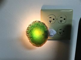 Green geode diffuses a soft light. Local artist.