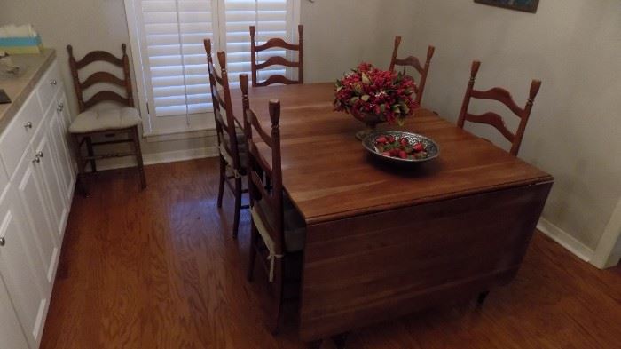 large drop leaf cherry table with 5 tall ladderback chairs