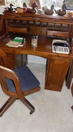 old roll top desk and chair