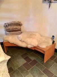 TEAK CURVED "ADJUSTABLE" BENCH. SHEEPSKIN THROW RUGS