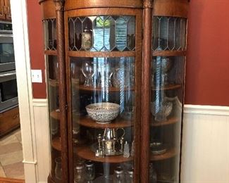 Antique bow front cabinet with leaded glass accents. This is a beautiful antique. 