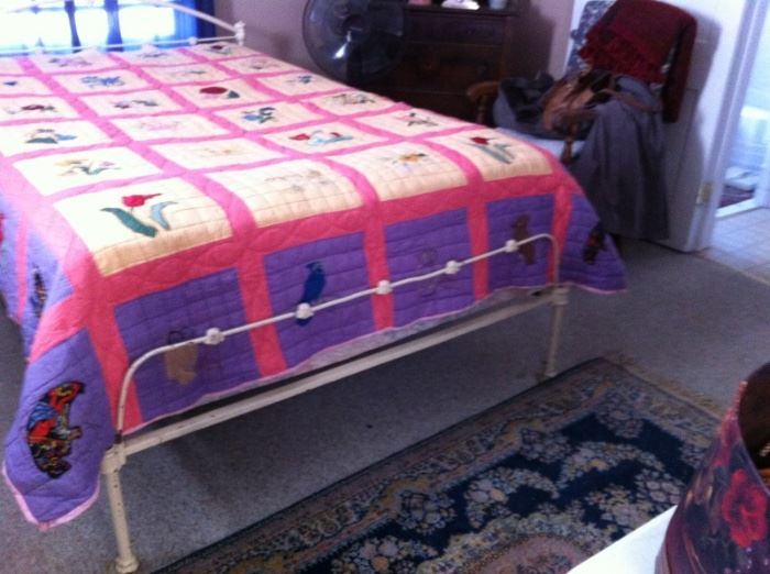 Wonderful Iron bed.  Full Size.  Quilt is hand done with embroidered and appliqued blocks