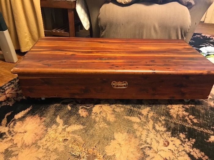 Cedar chest on casters that can roll under bed.