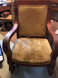 Mahoganzy rocker with wide arms and velvet seating and back - could be Empire Design