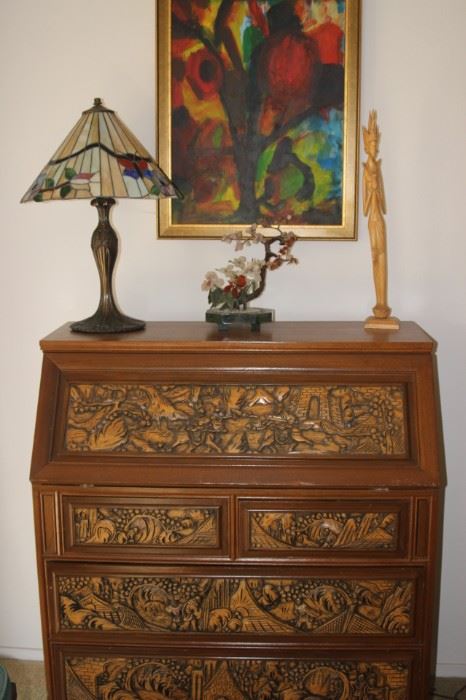 Hand carved drop down desk. Tiffany style table lamp. Stone tree and wood carving. Original framed art.