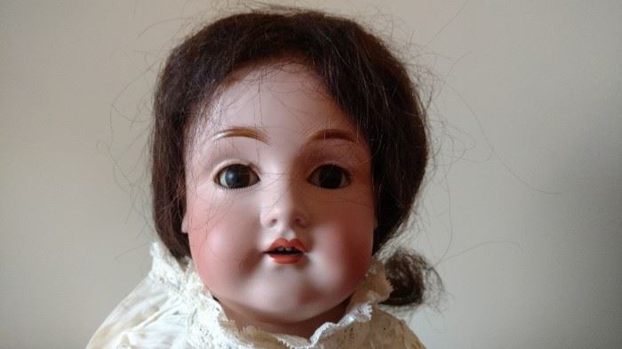Antique Bisque doll with leather body, sleepy eyes, teeth