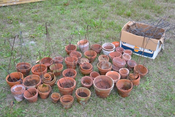 Assorted clay pots with hangers