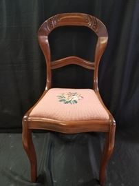 One of a set of four of Victorian balloon back chairs with needlepoint seats