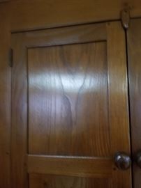 close up of pegs on Walnut corner cupboard