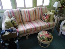 Rattan couch, pillows, and footstool