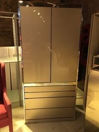 Ello cabinet with two doors over four drawers - would make a great bar. The front is reverse painted glass in a warm champagne color. Great condition.