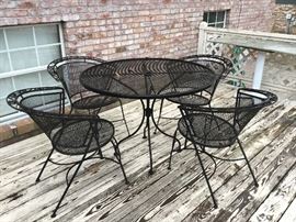 Round table with 4 matching wrought iron chairs