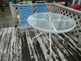 Round glass top patio table and 2 folding chairs