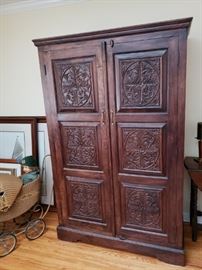 Carved panel storage cabinet