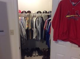 The closet is loaded with men’s shirts and ties and belts. Caps