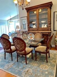 Glass top dining table with 6 custom upholstered chairs...Surya ‘Caesar’ wool rug measures 7’6”x9’6”.
